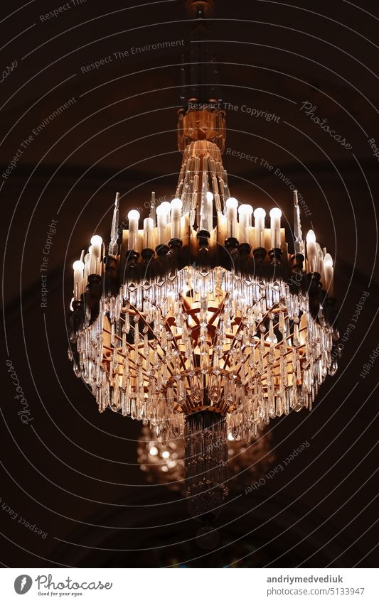 Elegant luxury crystal chandelier on ceiling, beautiful chandelier. Emphasis on luxury, used in various places such as palace church, residence..Decorative elegant vintage and Contemporary Concept.