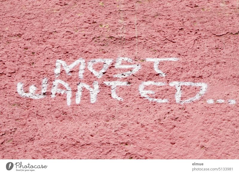 MOST WANTED ... is written in white block letters on an old pink wall Wall (building) most wanted English desire Like Sought-after search Blog Daub dusky pink