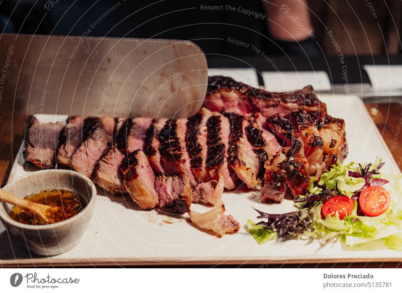 Excellent cuts of Argentine meat on a white plate america angus argentina asado background barbecue beef black board charcoal charred chateaubriand closeup