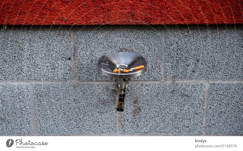 Ashtray with cigarette butts on the outside wall of a house Smoking cigarettes Cigarette Butt Harmful to health Nicotine Filter-tipped cigarette Health hazard