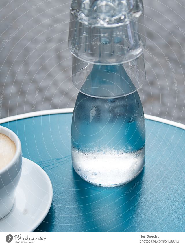 Turquoise table in street cafe with water carafe, glasses and latte Colour photo Café Cup Beverage Table Coffee break Coffee cup Close-up To have a coffee