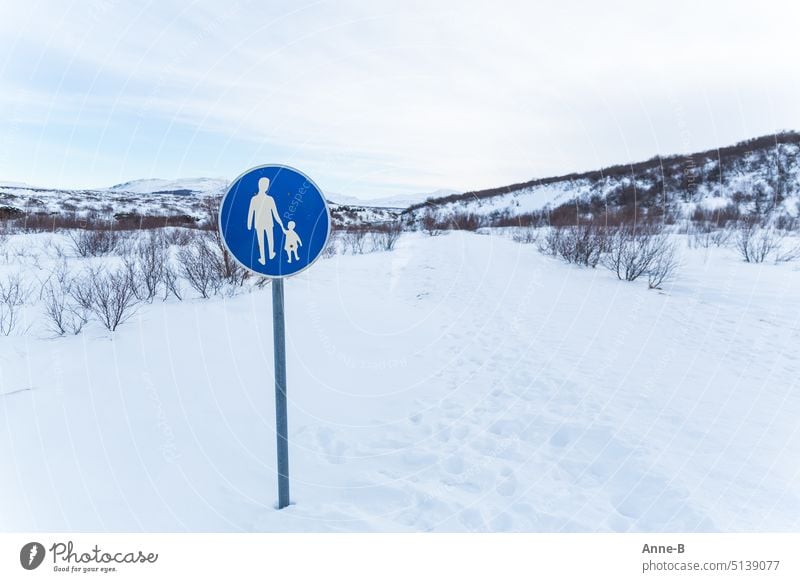 cute blue footpath sign on a bold snowy path in beautiful landscape Pedestrian pedestrian sign Blue off Man and child gender Gender justice Signage persons
