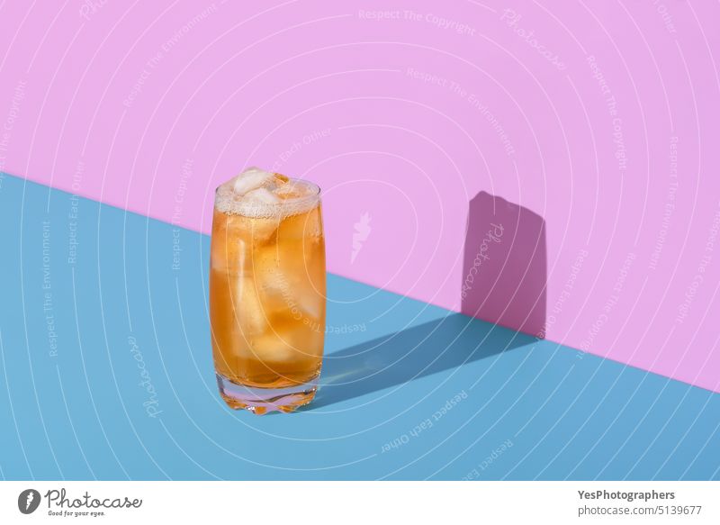 Ice tea glass isolated on a vibrant colored background abstract banner beverage blue bright cocktail cold colors cool copy space cubes delicious design drink