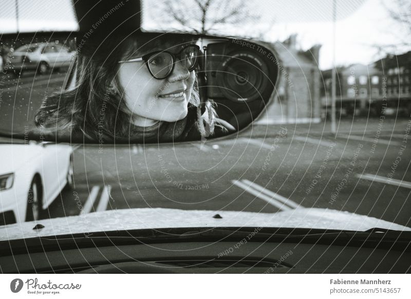 https://www.photocase.com/photos/5143657-young-woman-with-camera-and-glasses-in-car-rear-view-mirror-photocase-stock-photo-large.jpeg