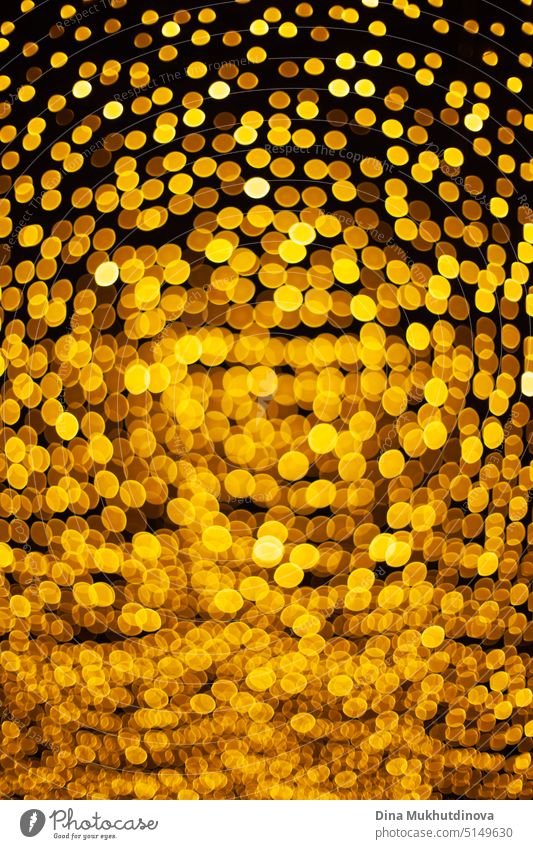 Vertical yellow bokeh bright lights pattern background at night, round shape gold lights as Christmas vacation festive backdrop clearer splendour Festive