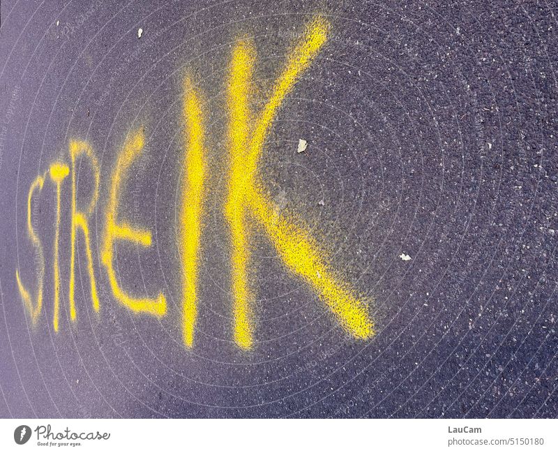 strike Strike Graffiti writing Call for strike call announcement Warn Warning label Letters (alphabet) Asphalt Street Yellow Gray Characters Typography Text