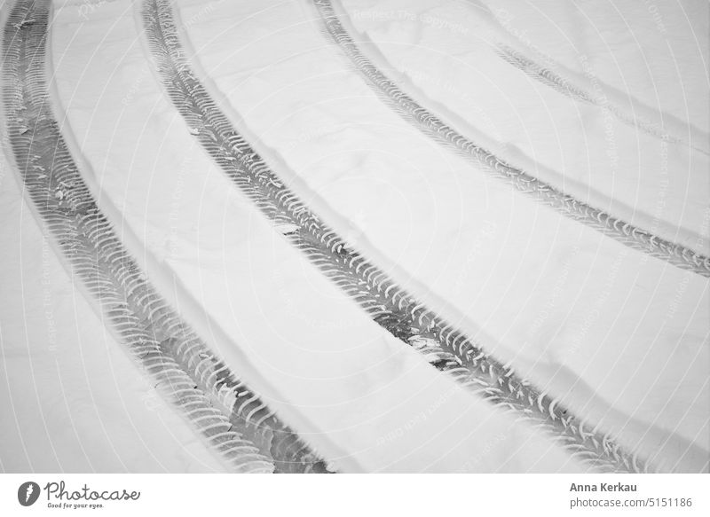 Tire tracks running side by side in the snow - a Royalty Free