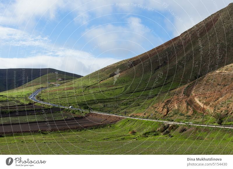 Road among the green mountains landscape view on sunny day. Heaven like nature with blue sky with clouds and green grass on mountains. icon religion symbol