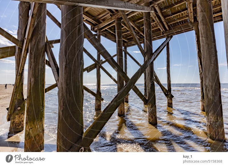 Wooden piles in the water of the North Sea in Sankt Peter Ording stakes Wooden stake wooden posts wooden planks Wood strip Construction Saint Peter Ording Beach
