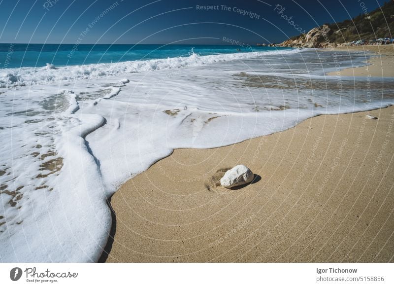 Waves on Milos sandy beach - Agios Nikitas village on Lefkada Ionian island, Greece. travel concept ionian greece foam levkada lit milos waves country