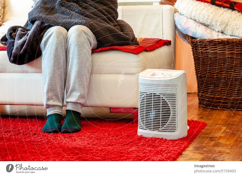 Heating season. Feet in socks. Heat room with fan heater electric heating at home. Warm period Holiday season feet Room Electric heating more adult Equipment