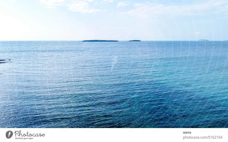 Rocky beach with blue sea at Cisterna Beach near Rovinj H2O Liquid Sea Swimming Water bathing copy space diving drip drops drowning fluid fresh historical humid