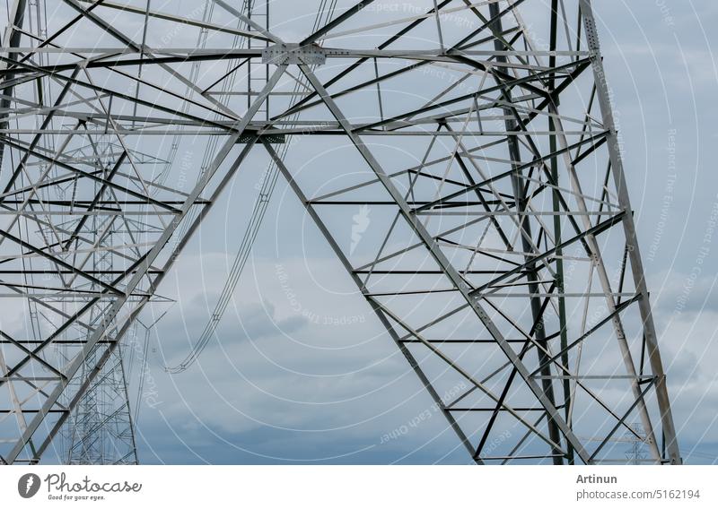High voltage electric transmission tower. High voltage power lines against blue sky. Electricity pylon and electric power transmission lines. High Voltage tower provide power supply. Power and energy.