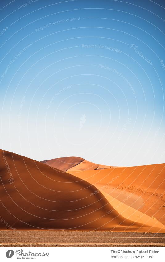 Sand dune with tracks against blue sky and sandstorm - a Royalty Free Stock  Photo from Photocase
