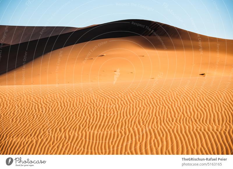 https://www.photocase.com/photos/5163165-sand-dune-pattern-against-blue-sky-namibia-desert-photocase-stock-photo-large.jpeg