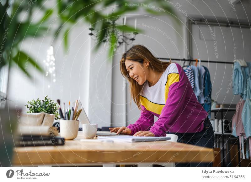 Young female freelancer working in loft office real people millennials student indoors window natural girl adult one attractive successful confident person