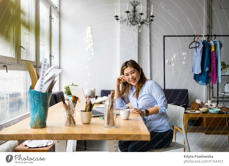 Confident young woman sitting at her desk stock photo (125531