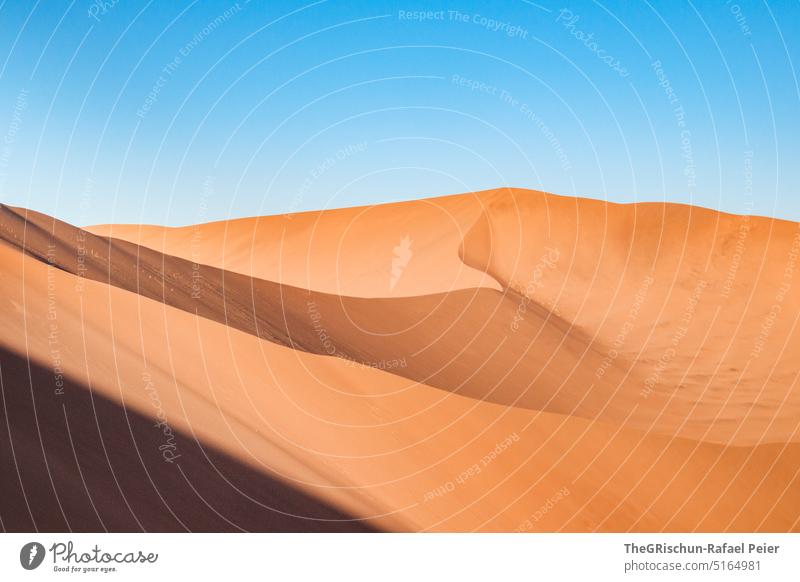 Sand dune pattern against blue sky - a Royalty Free Stock Photo from  Photocase