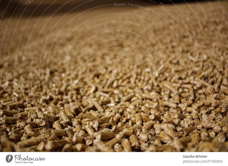 Photo of a pile of wood pellets with focus on lower part of the image and shallow depth of field Environment Heap warm Near Close-up detail Detail Material