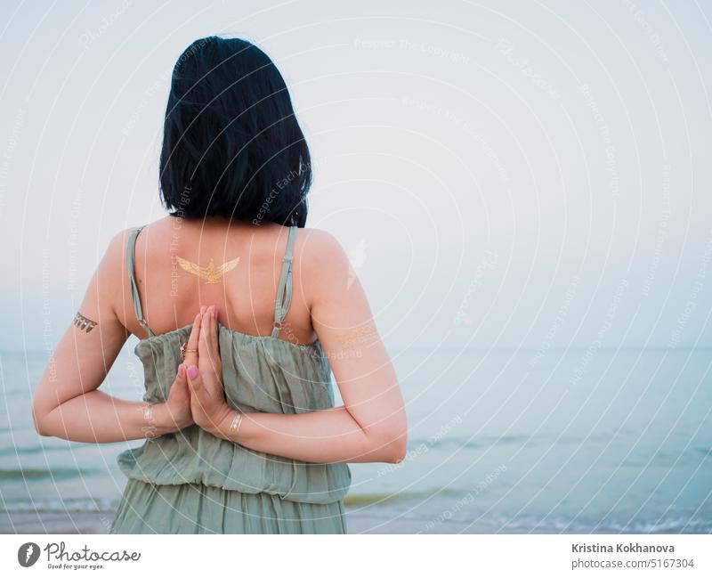 Woman practicing yoga. Namaste, meditation. Silver and golden flash tattoo artist background beach bead beautiful beauty body boho bracelet chic decorate