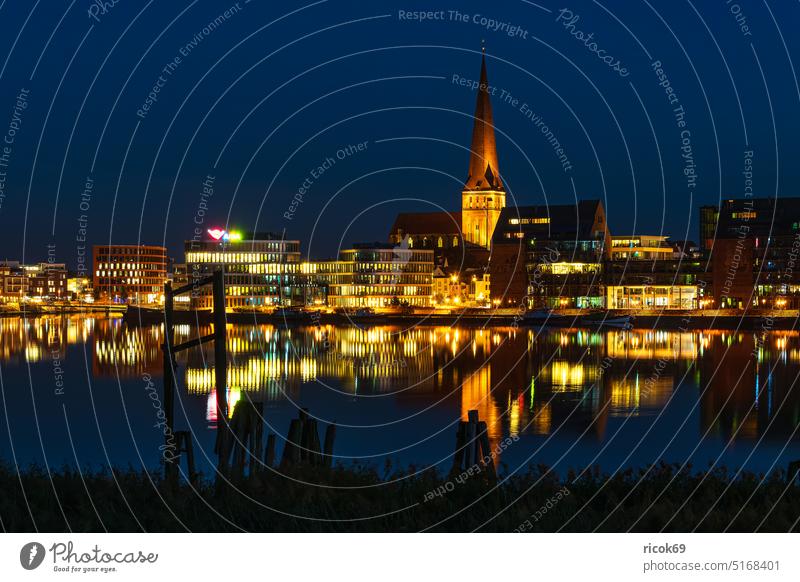 View over the Warnow to the Hanseatic City of Rostock in the evening Warnov River city harbour Mecklenburg-Western Pomerania Town Church Petri church