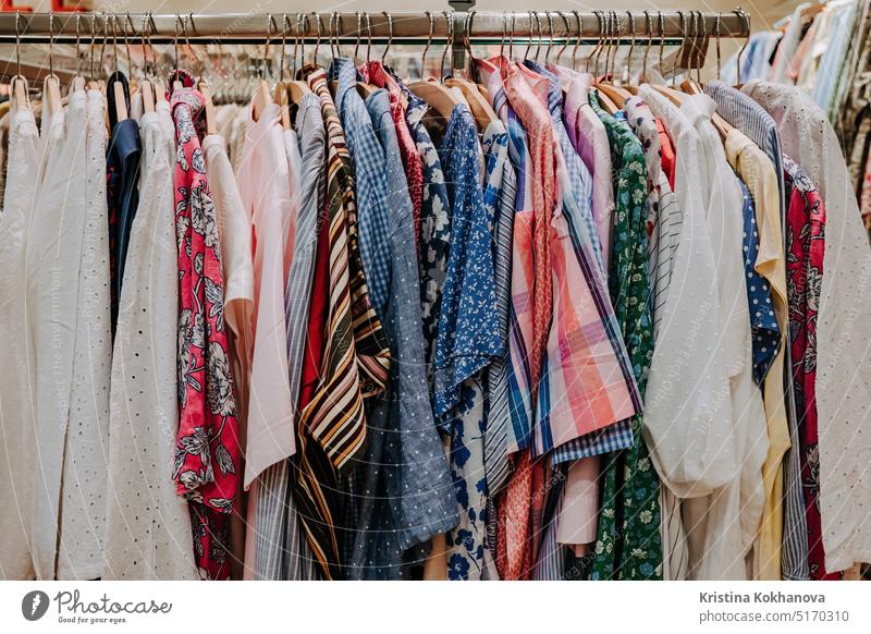 https://www.photocase.com/photos/5170310-colorful-summer-clothes-hang-on-shelf-hangers-in-store-modern-fashion-sale-photocase-stock-photo-large.jpeg