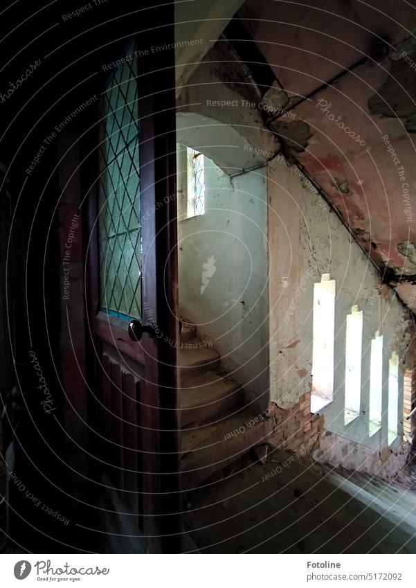 The staircase of a long abandoned church is slowly decaying. The doorknob, however, shines like new. Everything else here is totally dirty and dusty. How mysterious!