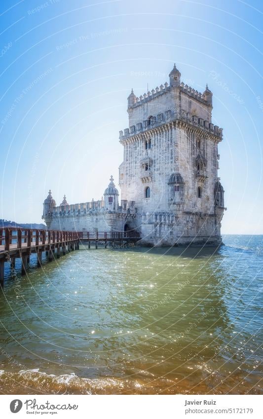 Belem defensive tower in the estuary of the Tagus river in Lisbon, footbridge over the water that leads to the interior, vertical lisbon portugal belem tower
