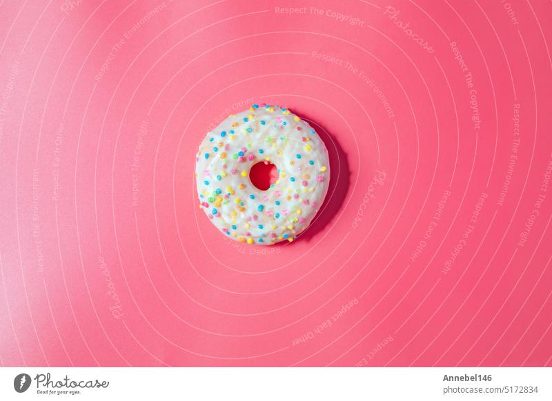 Donuts with icing on pastel pink background. Sweet donuts. top view assorted with various chocolate glazed and sprinkles, sugar sweets concept dessert doughnut