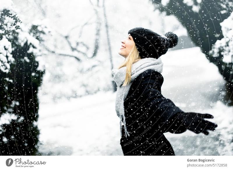 Winter woman in the snow. Beautiful girl in the winter in nature