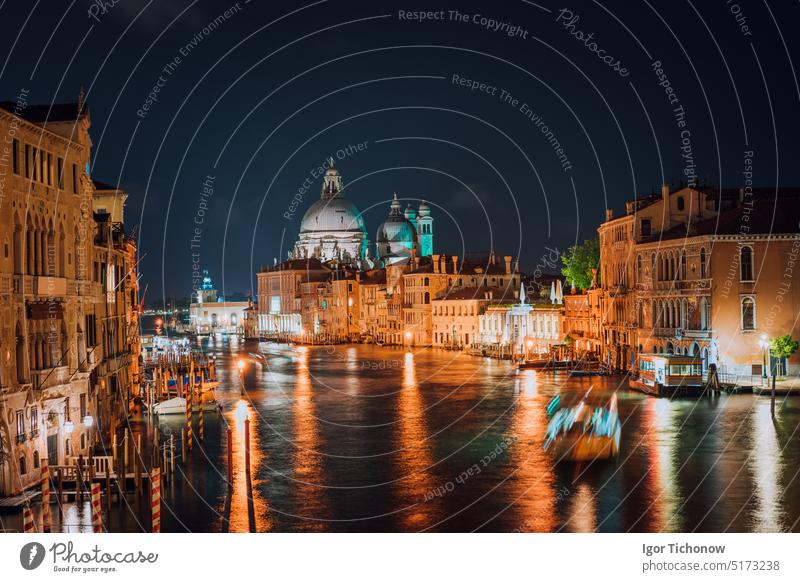 Venice, Italy. Majestic Basilica di Santa Maria della Salute at night. Grand Canal light reflected on water surface. italy canal venice basilica illuminated