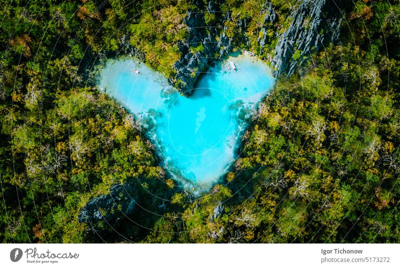 Aerial top view of turquoise lagoon shaped heart inside of tropical island. Love travel summer vacation concept love beach aerial blue coast landscape ocean
