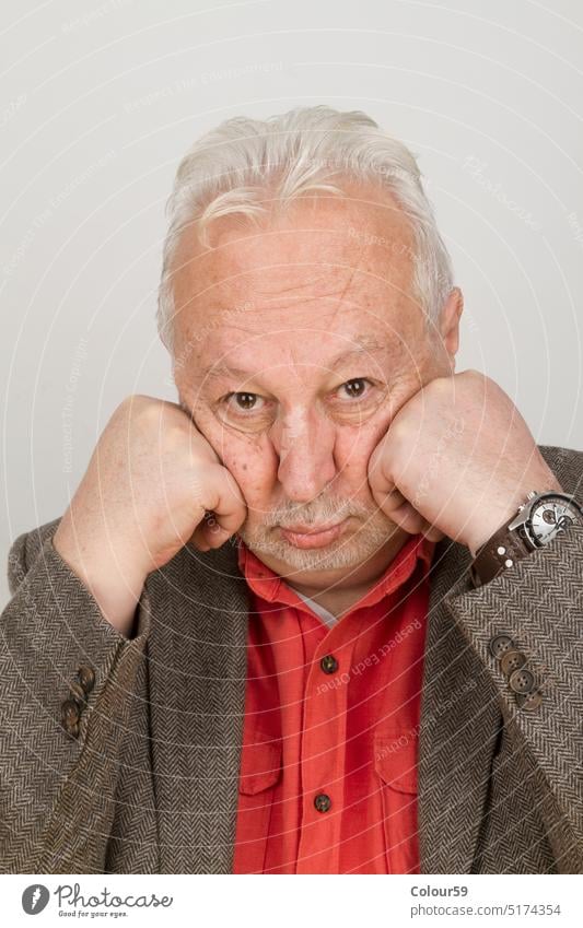 Elderly person puts his face in his hands white background senior man elderly portrait caucasian expression handsome facial adult old male hair studio pouting