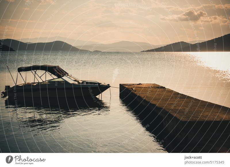 Mooring for motor boat in the last light of the day Motorboat Footbridge Berth Vacation & Travel Sky Clouds Sun Warmth coast Beach Hill Ocean Bay Greece Horizon