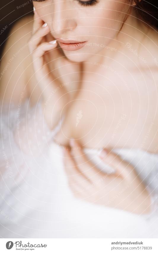 beauty concept. portrait of a beautiful young showy brunette woman with bright pin-up make-up in pink curlers. Studio Shot, Cropped. Facial treatment . Cosmetology , skin care and spa