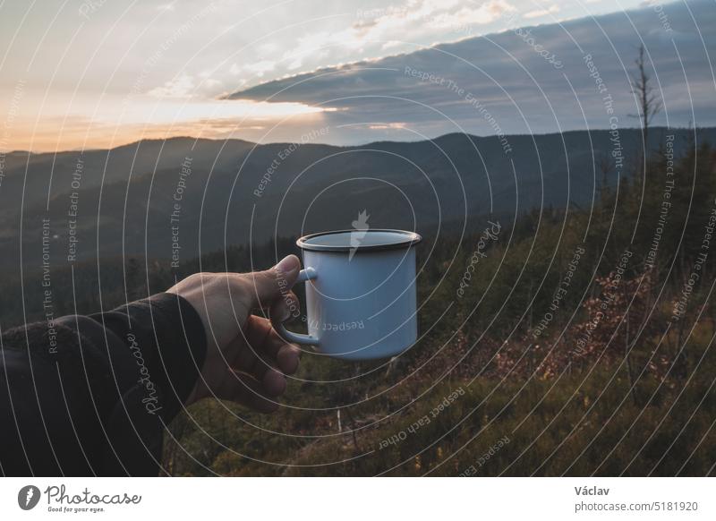 Beautiful morning on top of a hill in Beskydy mountains, Czech Republic. Enjoying a warm cup of tea after work. Hiking lifestyle freedom one person wilderness