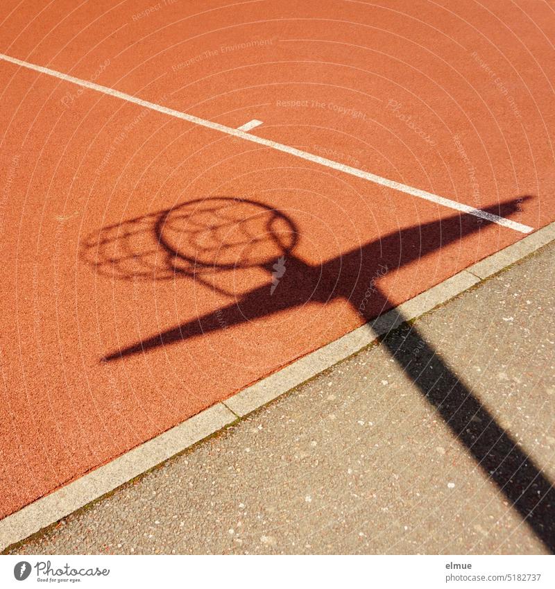 Shadow of basketball hoop with net on a red sports flooring / playing basketball Basketball Basketball basket Basketball hoop with net Playing field