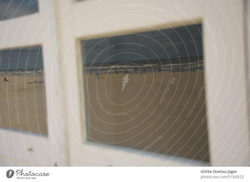 Mirror image in window panes / beach life on the North Sea coast Beach life reflection Reflection in windows Window Window pane Window in a beach hut slices