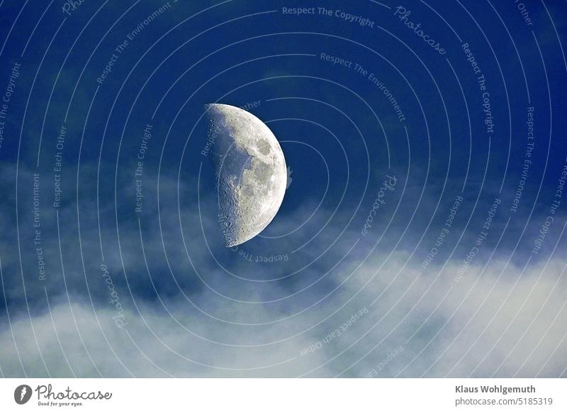 Increasing crescent moon in dark blue evening sky with light clouds, moon craters and moon seas are visible Moon Half moon Sky Clouds cloudy sky terminator