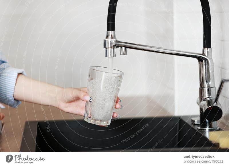 Filling glass of mains water, drinking water close-up. concept of pure drinking water. Water quality check concept. The concept of saving, problems with water