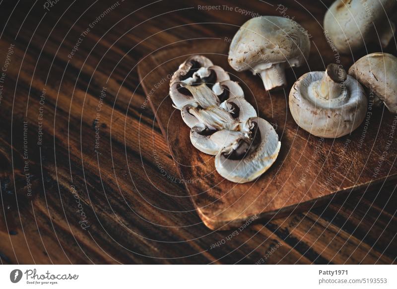 White mushrooms on a dark rustic wooden board Button mushroom Food Mushroom Nutrition Vegetarian diet Food photograph Healthy Eating Organic produce Wood Rustic