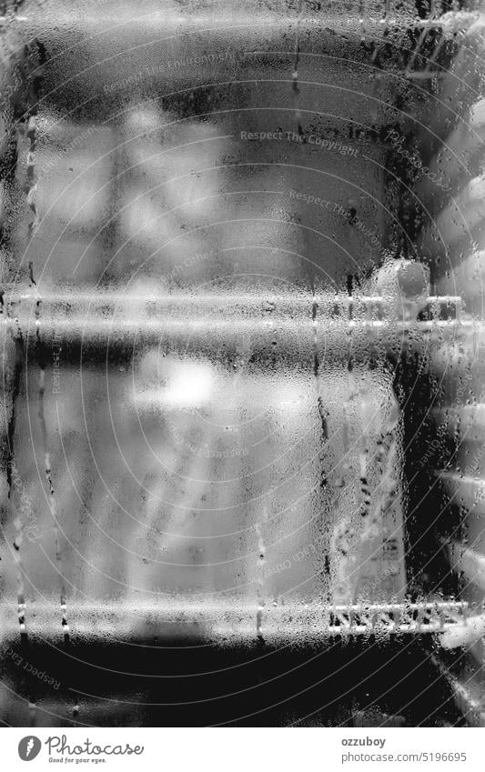 Black and white of water droplets on the glass of the refrigerator. Condensation conditions of the water in the fridge background condensation wet transparent