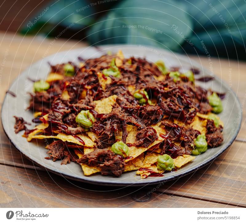 Mexican nachos with beef and chilli on wooden table appetizer assorted assortment avocado background bar cheese chili chili con carne chili pepper chip chips