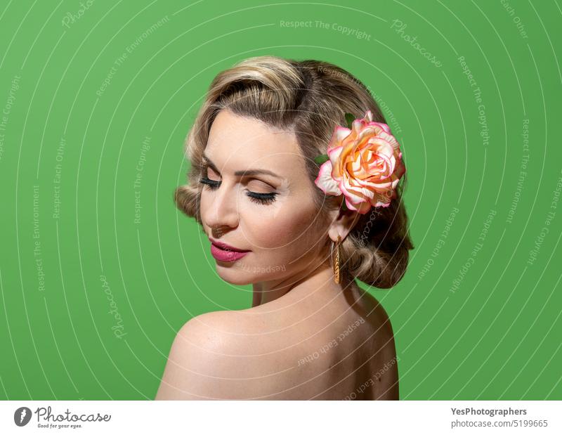 Pin up woman portrait with retro hairstyle and make up, against a green  background - a Royalty Free Stock Photo from Photocase