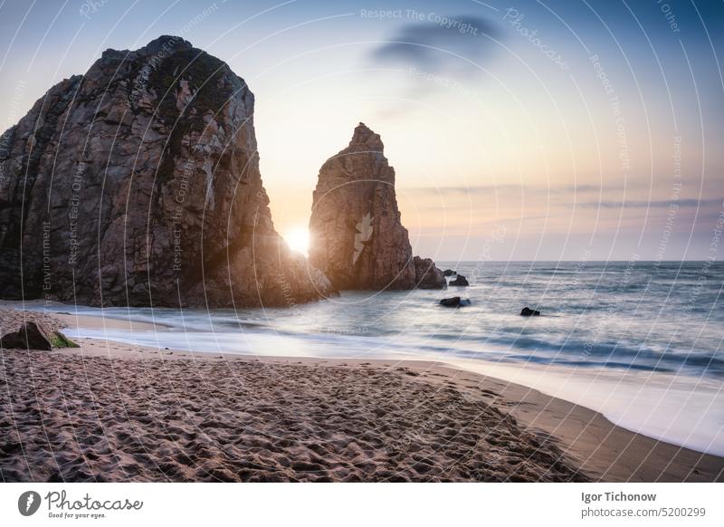 Sunset at Ursa Beach Sea stack, Portugal. Atlantic Ocean Foamy waves rolling to sandy beach. Holiday vacation landscape scene ursa portugal coast travel