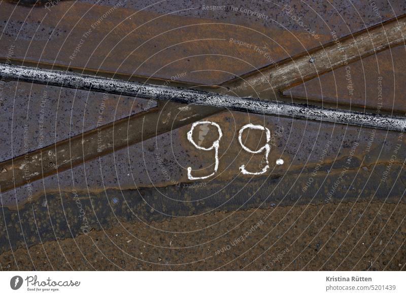 99. streetcar rails ninety-nine number Numbering mark characteristics Street tram tracks Numbers benumbers number through label Asphalt Ground Metal