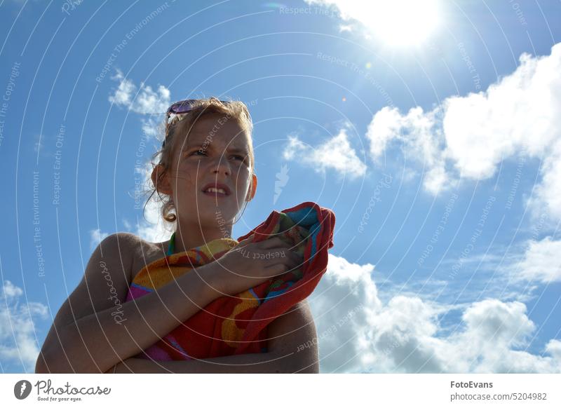 Young girl with a towel under blue sky with bright sun Girl Sun Sky be afloat Child Woman Blue