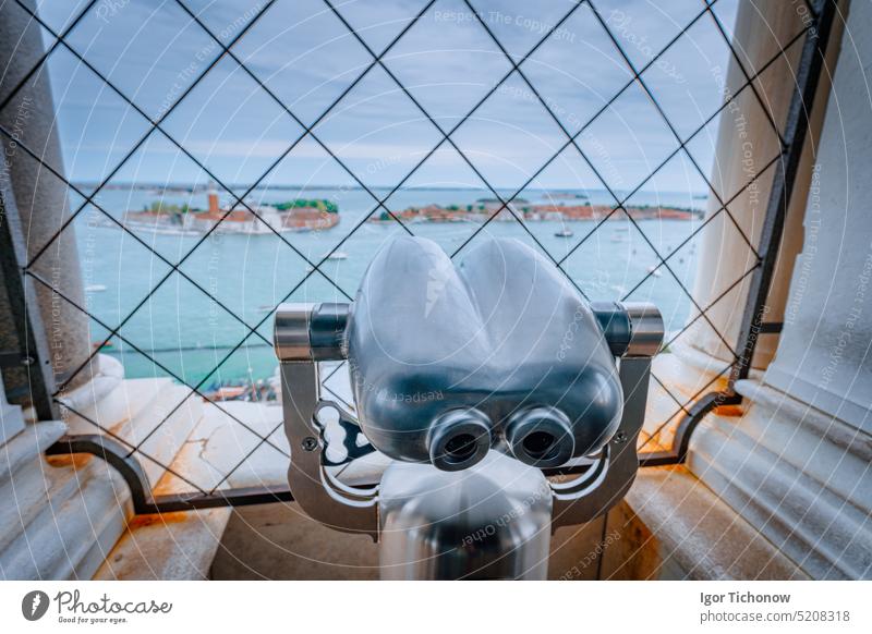 Binoculars in the Clock Tower of Venice, Italy with Chiesa di San Giorgio Maggiore blurred in background. Travel, vacation and tourism concept honeymoon della