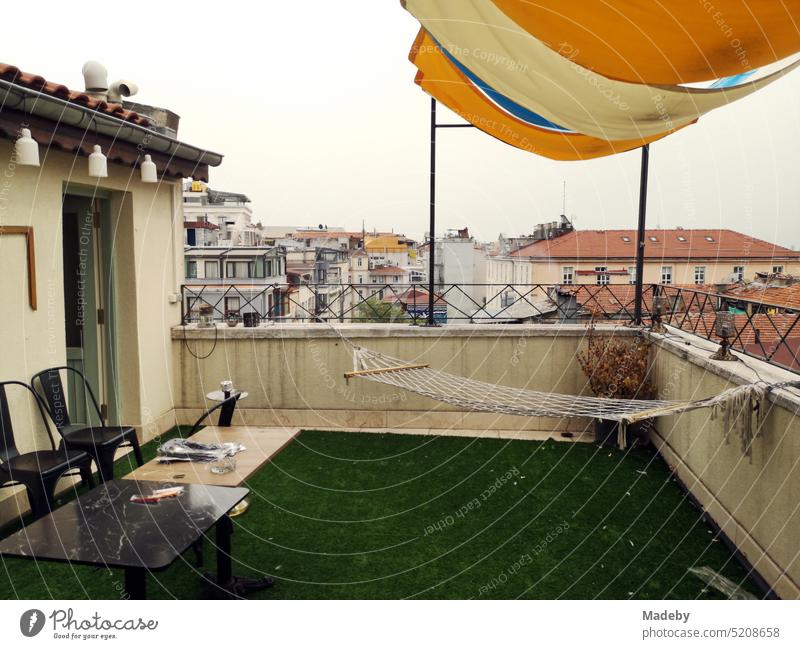 Hammock with awning on the roof terrace of a hotel in the old town of Taksim in summer at the Istiklal Caddesi in the Beyoglu district of Istanbul on the Bosporus in Turkey