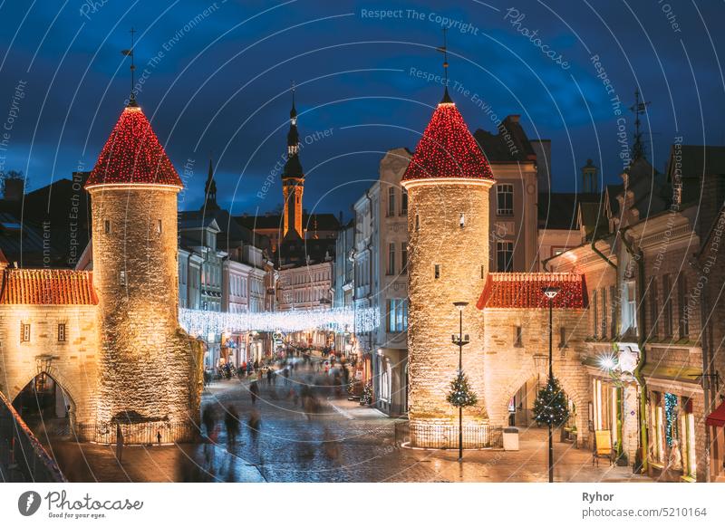 Tallinn, Estonia. Famous Landmark Viru Gate In Street Lighting At Evening Or Night Illumination. Towers In Christmas Holidays Decorations street night tallinn